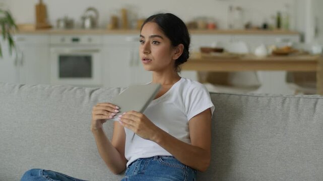 Overheated Indian woman at home wave copybook textbook notebook refresh sweaty Arabian lady girl female suffer of high temperature problem summer feel sweat hot air conditioner broken climate control