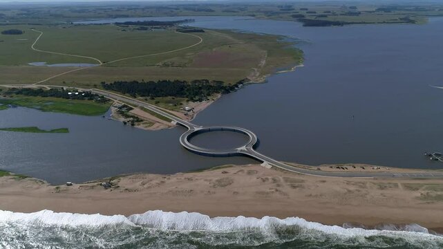 Aerial view of Laguna Garzon Bridge with cars and tranquil waters, Maldonado, Uruguay.