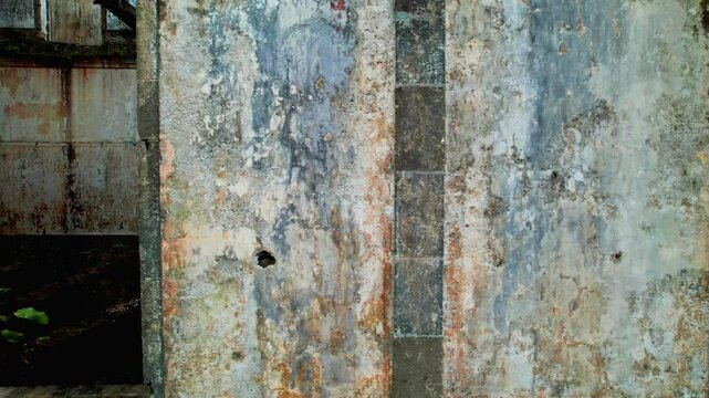 Aerial view of weathered ruins with moss-covered walls and a doorway, Parque Grena, Sao Miguel, Portugal.