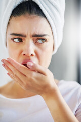 Dental, woman and check bad breath with hand for health or disgust for halitosis in home bathroom....