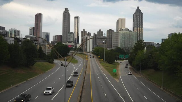 4k panoramic view of Atlanta skyline with slow moving traffic shot from old fourth ward on Jackson street bridge in downtown Atlanta