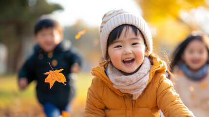 Happy Asian Girl with Multiracial Friends Plays with Autumnal Leaves Outdoors on Sunny Fall Day, Children Fun.