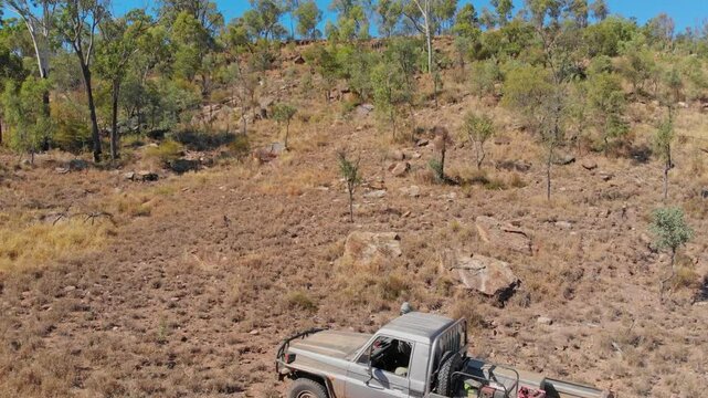 Aerial view of dry outback with rugged mountains and scattered vegetation, Mackenzie River, Queensland, Australia.