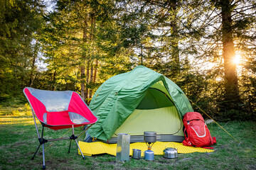 Camping with a tent and cooking equipment in the mountains.