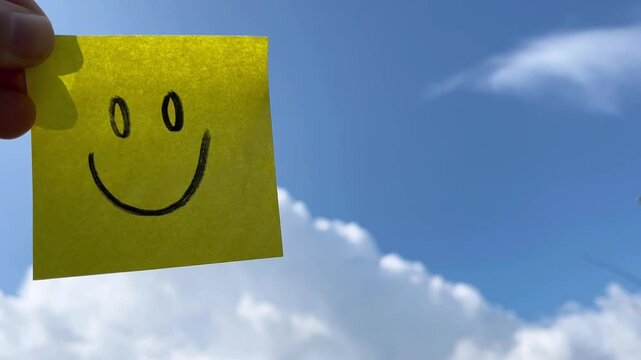 Happy post it note on sky