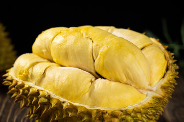Fresh peeled ripe durian on wooden table.