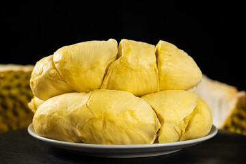 Fresh peeled ripe durian on wooden table.