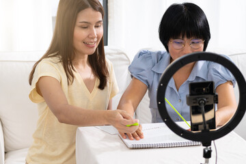 Teaching Braille to visually impaired individuals, the instructor patiently guides them through...