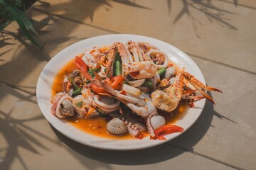 Seafood platter with shrimp, crab, and vegetables served on a white plate
