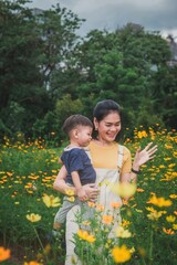 Mother and child smiling together in a field of yellow flowers
