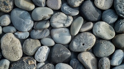 Close-up of smooth, grey and white pebbles.