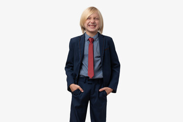 Blond grimacing boy in a blue suit and a red tie. Isolated on white background.