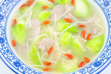 A bowl of loofah, lean meat, enoki mushroom soup