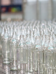 Glass factory, production of glass containers. Molten glass is blown into molds. Robotics in industry. Modern technologies, robotic machines produce products. Technological work at the plant.