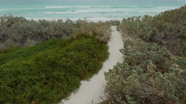 Aerial view of beautiful sandy beach with dunes and waves, Geraldton, Australia.