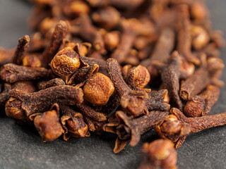 A close-up of aromatic cloves, highlighting the texture and rich color