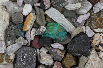 Tightly packed mixture of mine, mining ores, commodities, metals, coal. Background concept, texture, rocks. Variety, mixed, many, multi-colored, colorful. Bear, bull market.