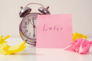 Clock with sticker “Then later”: a symbol of procrastination, a reminder that sometimes you...