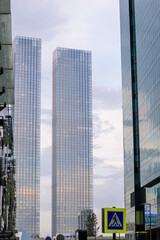 Obraz premium Modern Moscow City towers against a blue sky. Tall glass skyscrapers with mirror