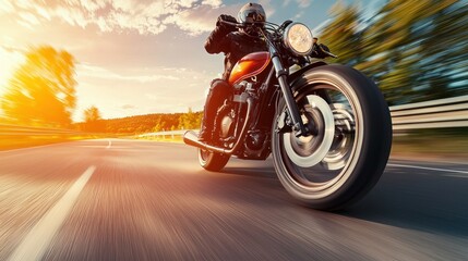 Naklejka premium Motorcycle revving up on an open road with motion blur to convey speed and acceleration