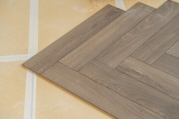 Professional laminate flooring installation in a bright apartment interior. 