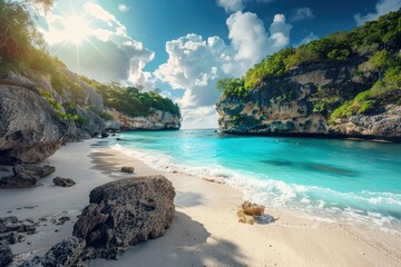 Fototapeta premium Beautiful tropical beach with turquoise water, white sand, and lush green cliffs under a bright blue sky. A perfect getaway destination.