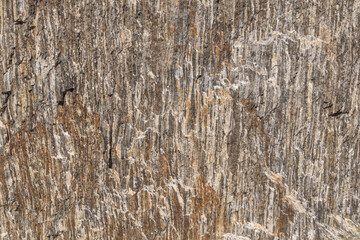 Obraz premium A close-up texture of a layered, weathered rock formation with varying shades of gray. Backgrounds