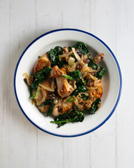Delicious Rabbit stewed with spinach and raisins. Top view table.