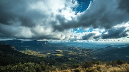 Fototapeta premium A panoramic view of a mountainous landscape under a dramatic sky with clouds.