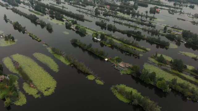 Aerial view of flooded islands with houses surrounded by serene water and lush greenery, Breukelen, Netherlands.