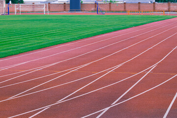 Obraz premium athletic running track around soccer field sport complex urban empty space without people
