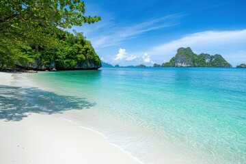 Fototapeta premium Scenic tropical beach with crystal clear blue waters and white sandy shores.