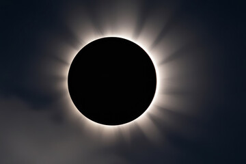 A beautiful solar eclipse captured at the moment when the Moon partially covers the Sun, creating an atmosphere of mystery and beauty