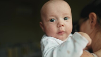 baby a newborn drooling from mouth. happy family kid dream concept. mom holds baby son in her arms, he is drooling, dad wipes saliva with a handkerchief lifestyle