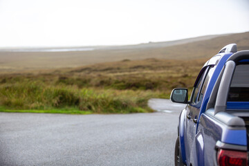 Blue truck in isolated car park, Image shows a blue pick up truck parked in the car park along Committee road facing out to the open moorland in search of birds of prey © J.Woolley