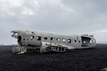 Abandoned Aircraft Wreck on Black Volcanic Beach