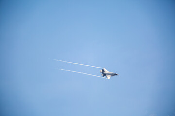F35 Lightning flying over RAF Lakenheath during sunset creating wingtip vortex's, from a public road