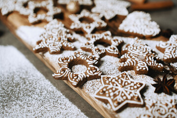 hand-decorated christmas cookies on a wooden background