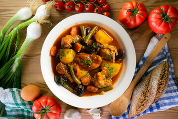 Delicious Rabbit stewed with vegetables and potatoes. Top view table with christmas decoration.