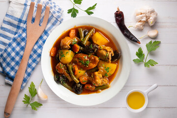 Delicious Rabbit stewed with vegetables and potatoes. Top view table with christmas decoration.