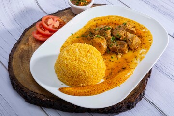 A mouthwatering dish of Seco de chivo chancho featuring a rich and savory sauce, served with tender chunks of goat, pork, and beef. Accompanied by a generous portion of moros de lenteja (lentil rice)