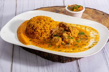 A mouthwatering dish of Seco de chivo chancho featuring a rich and savory sauce, served with tender chunks of goat, pork, and beef. Accompanied by a generous portion of moros de lenteja (lentil rice)
