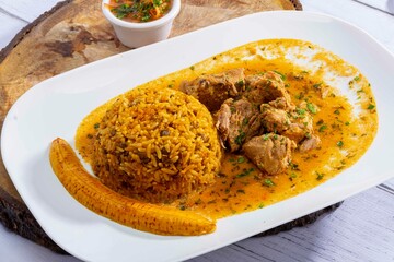 A mouthwatering dish of Seco de chivo chancho featuring a rich and savory sauce, served with tender chunks of goat, pork, and beef. Accompanied by a generous portion of moros de lenteja (lentil rice)