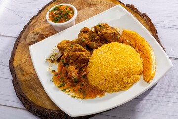 A mouthwatering dish of Seco de chivo chancho featuring a rich and savory sauce, served with tender chunks of goat, pork, and beef. Accompanied by a generous portion of moros de lenteja (lentil rice)