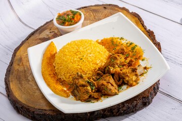 A mouthwatering dish of Seco de chivo chancho featuring a rich and savory sauce, served with tender chunks of goat, pork, and beef. Accompanied by a generous portion of moros de lenteja (lentil rice)