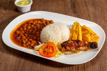 Deliciously charred and smoky Pollo a la Brasa (grilled chicken) served whole and in pieces, accompanied by crispy fries, fresh salad, and a flavorful dipping sauce. A classic Latin American dish, coo