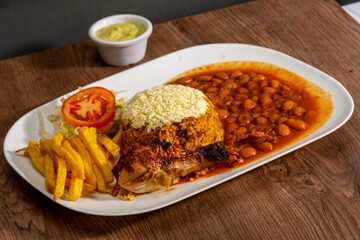 Deliciously charred and smoky Pollo a la Brasa (grilled chicken) served whole and in pieces, accompanied by crispy fries, fresh salad, and a flavorful dipping sauce. A classic Latin American dish, coo