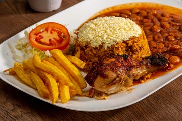 Deliciously charred and smoky Pollo a la Brasa (grilled chicken) served whole and in pieces, accompanied by crispy fries, fresh salad, and a flavorful dipping sauce. A classic Latin American dish, coo