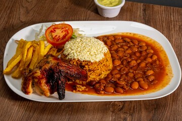 Deliciously charred and smoky Pollo a la Brasa (grilled chicken) served whole and in pieces, accompanied by crispy fries, fresh salad, and a flavorful dipping sauce. A classic Latin American dish, coo