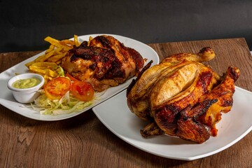 Deliciously charred and smoky Pollo a la Brasa (grilled chicken) served whole and in pieces, accompanied by crispy fries, fresh salad, and a flavorful dipping sauce. A classic Latin American dish, coo